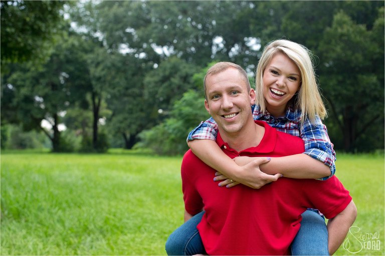 Engaged couple laughing and smiling while piggy back riding