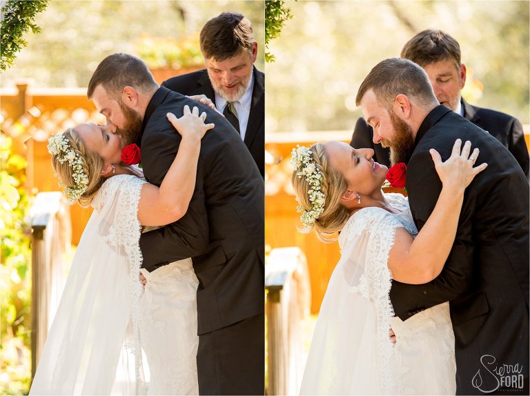 Bride and groom first kiss in garden ceremony