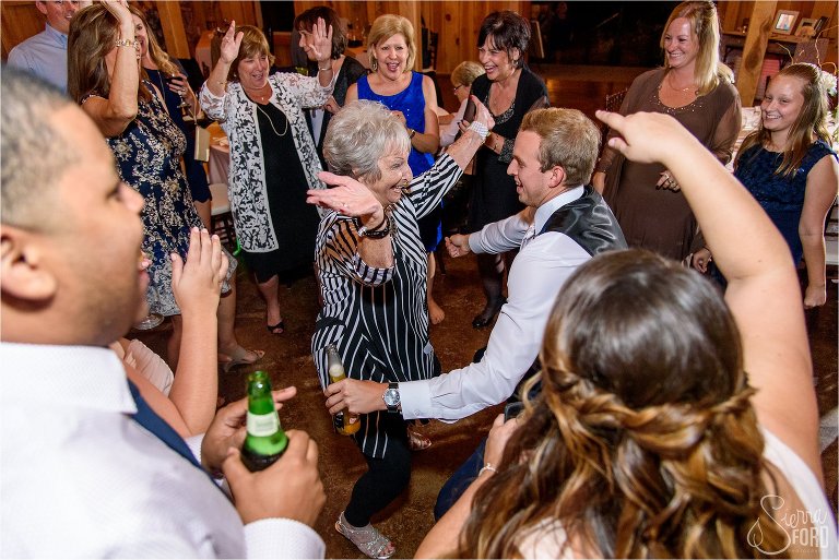 Reception dance floor in barn wedding with dancing guests