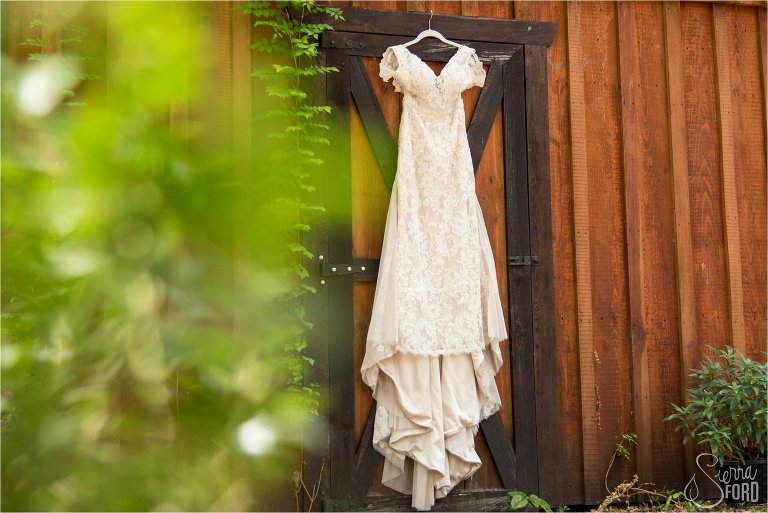 Wedding dress hanging on barn door