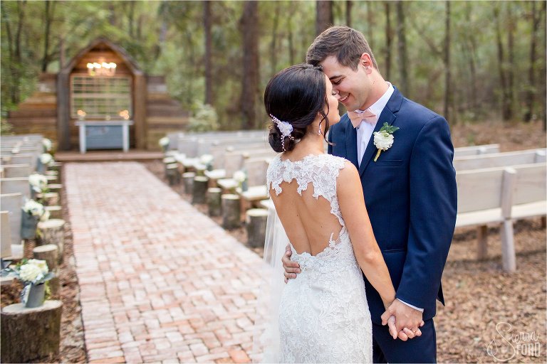 Bride and groom kissing and holding hands