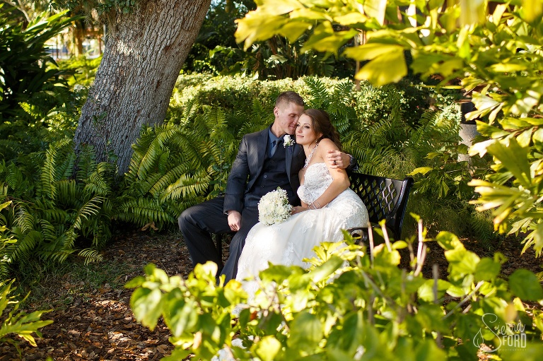 Bride and groom sitting in garden at Tavares Pavilion