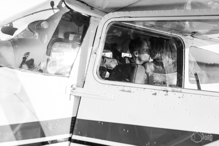 Bride and groom kissing inside seaplane at Tavares Pavilion