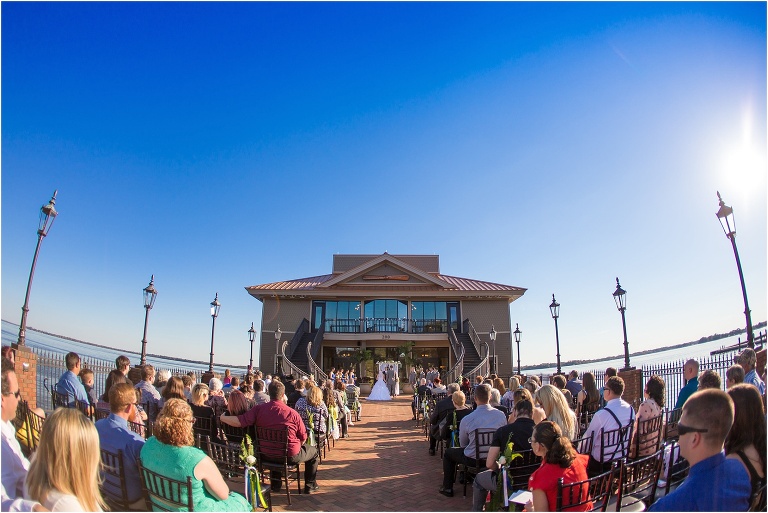 Wide angle shot ceremony shot during beautiful lakefront wedding