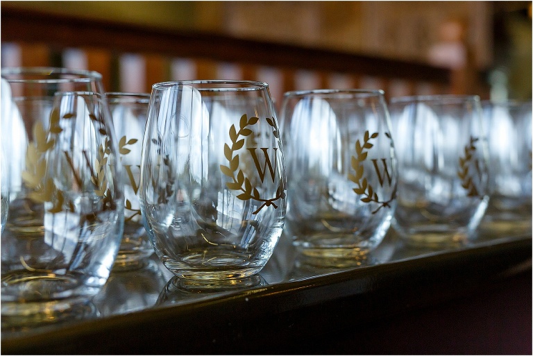 Customized glasses with their initial "W" etched on in gold leaf for wedding favors