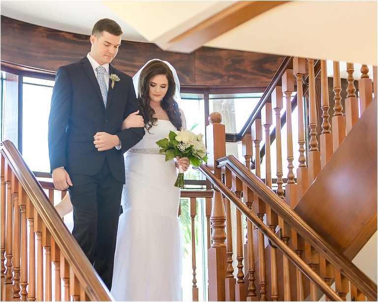 The bride descending the grand staircase at Tavares Pavilion on her brother's arm