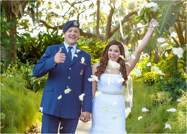 Bride & groom running through flower petals as husband and wife