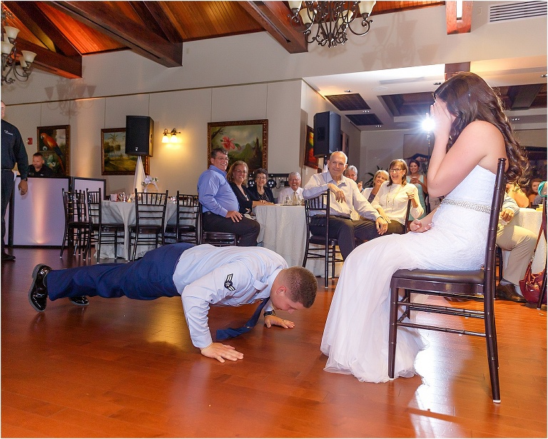 The groom does pushups before diving under his bride's dress to fetch her garter with his teeth