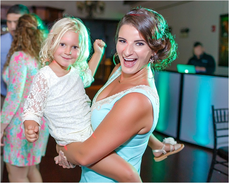 A bridesmaid and the flower girl dancing the night away together