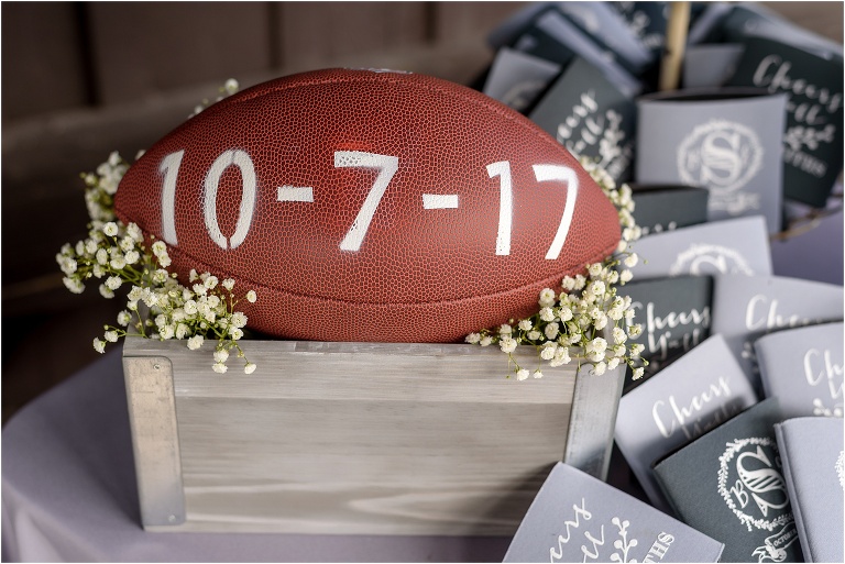 A football with their wedding date written on it welcomes guests