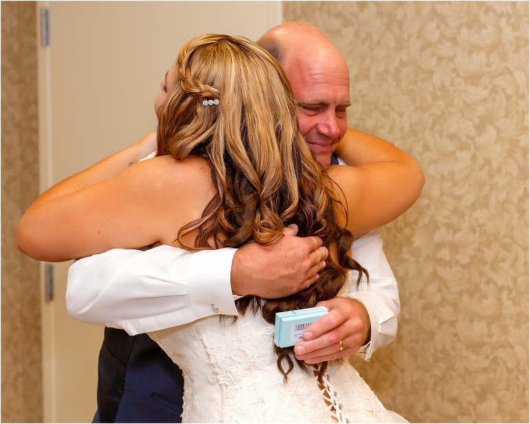 The bride's father gets emotional after seeing his baby girl in her wedding dress for the first time
