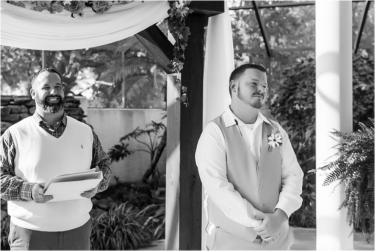 tears well up in the groom's eyes as he sees his bride coming down the aisle