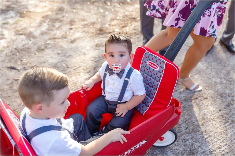 the wedding's youngest guests take a ride in a Red Flyer