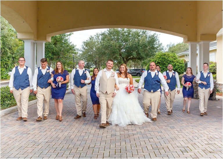bride & groom and their wedding party take a walk together