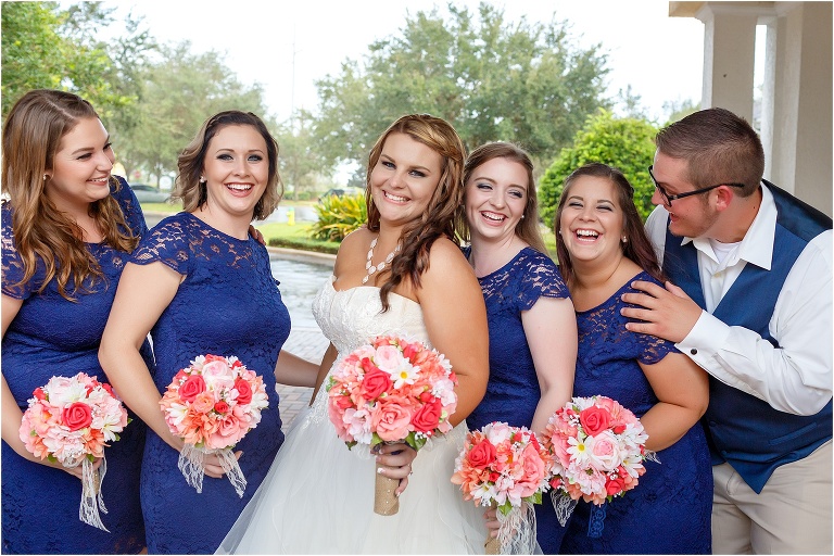 the bride shares a laugh with her bridesmaids and man of honor