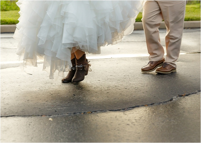 a peek of the bride's cowboy boots under her gorgeous dress from David's Bridal