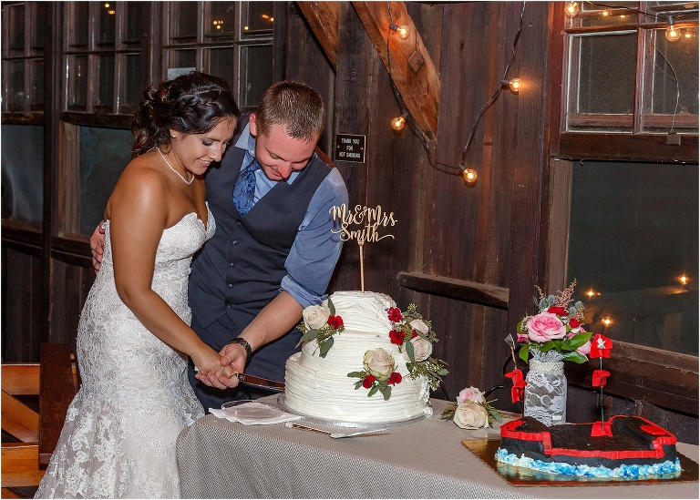 Bride and groom cut their wedding cake together