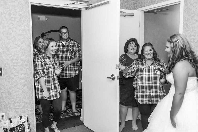 The bride's bridesmaids get to see her for the first time in her wedding dress from David's Bridal