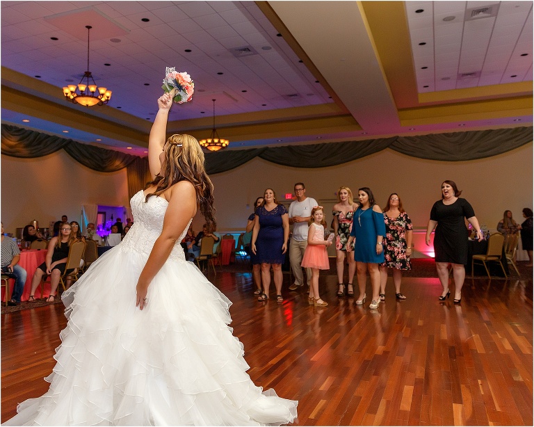 the bride throws the bouquet to her single lady guests