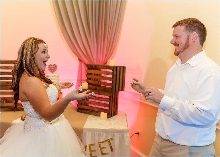 the groom squishes cake into the bride's forehead