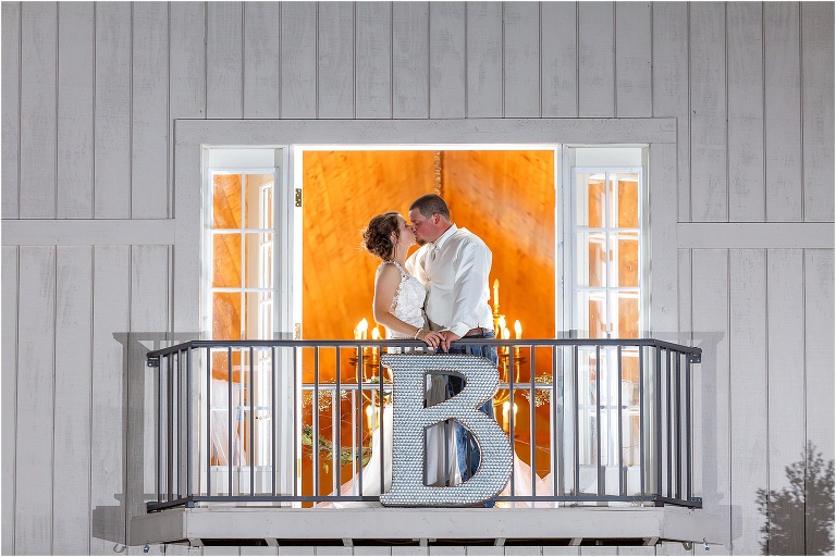bride and groom kissing at October Oaks Barn