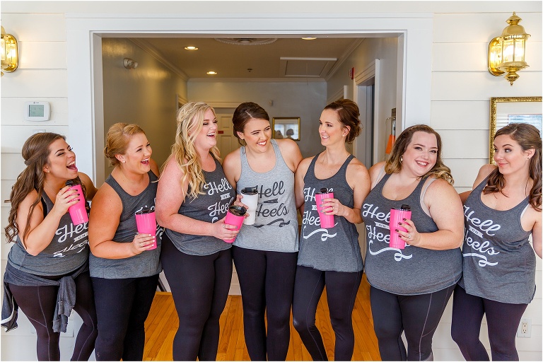 Bride & her bridesmaids laugh in their matching "Hell on Heels" shirts