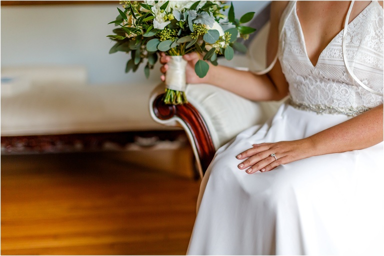 the bride takes a moment on the chaise in her uniquely designed Hayley Paige dress 