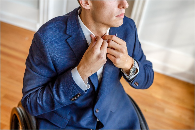 the groom buttons up as he gets ready at the Cypress Grove Estate House