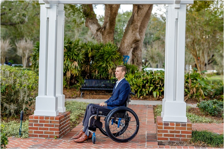 the groom awaits his bride between the columns at Cypress Grove Estate House