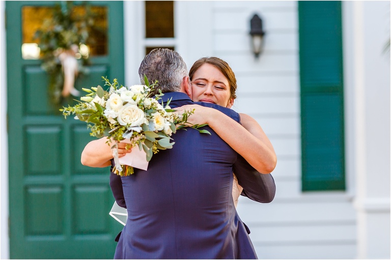 the bride cries as she hugs her father in front of Cypress Grove Estate House before he walks her down the aisle