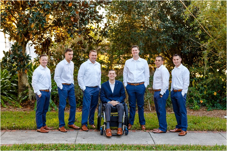 The groom & his groomsmen in their casual navy pants and light brown shoes