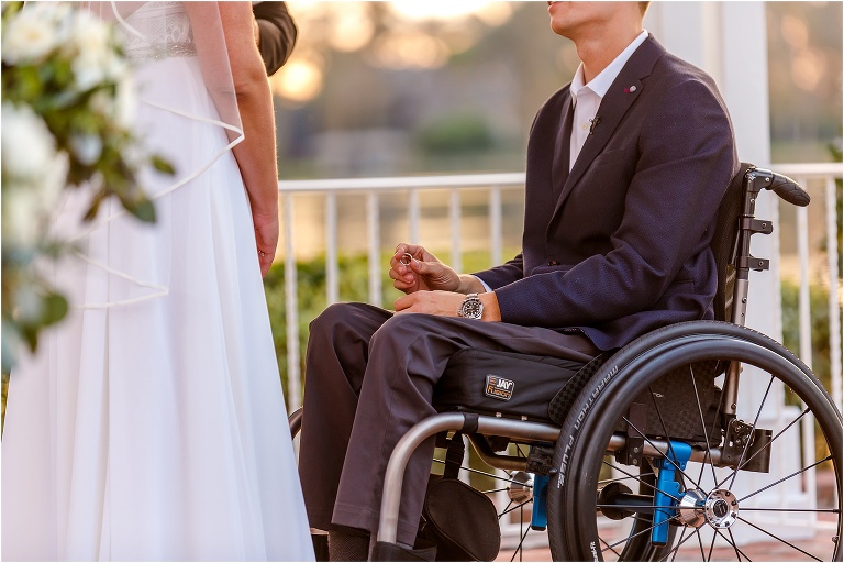 the groom prepares to place his bride's ring on her finger during their Cypress Grove ceremony