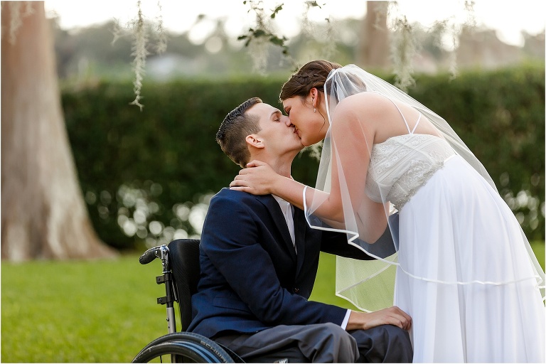 the bride & groom kiss under the hanging Spanish Moss