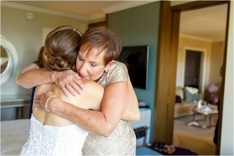the mother of the bride hugs her daughter after giving her emotional card before her wedding