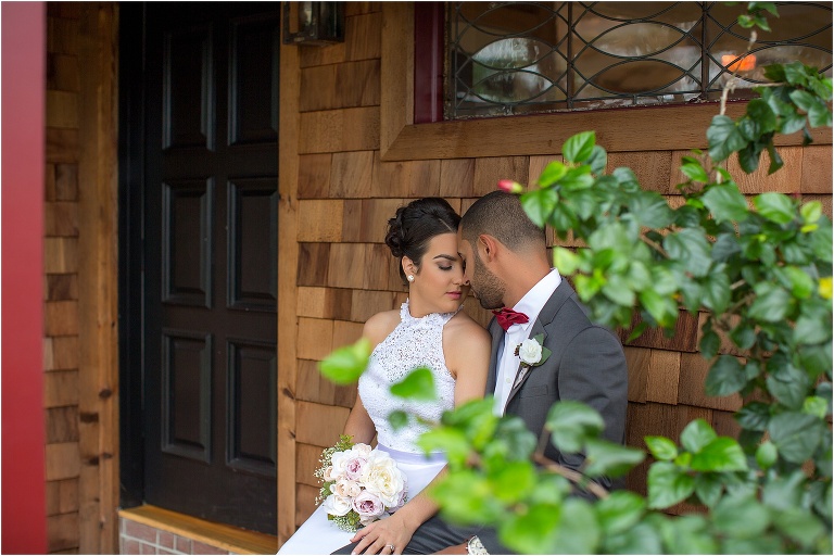 the bride and groom forehead to forehead on the porch at The Acre Orlando