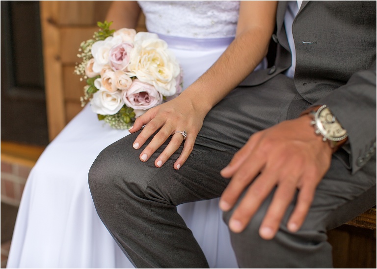 the couple's hands as they sit together before their ceremony