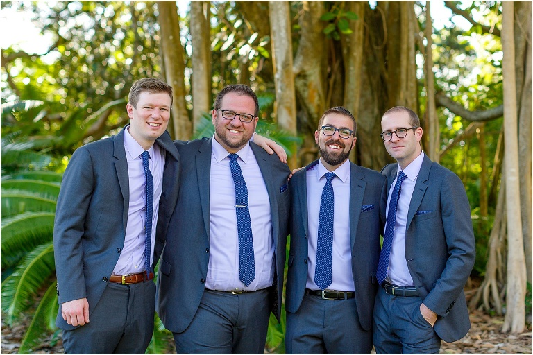 the groom and his groomsmen looking dashing in their slate blue Indochino suits