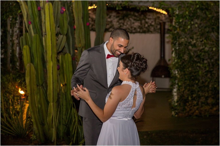 the bride and groom laugh as they share their first dance at The Acre Orlando