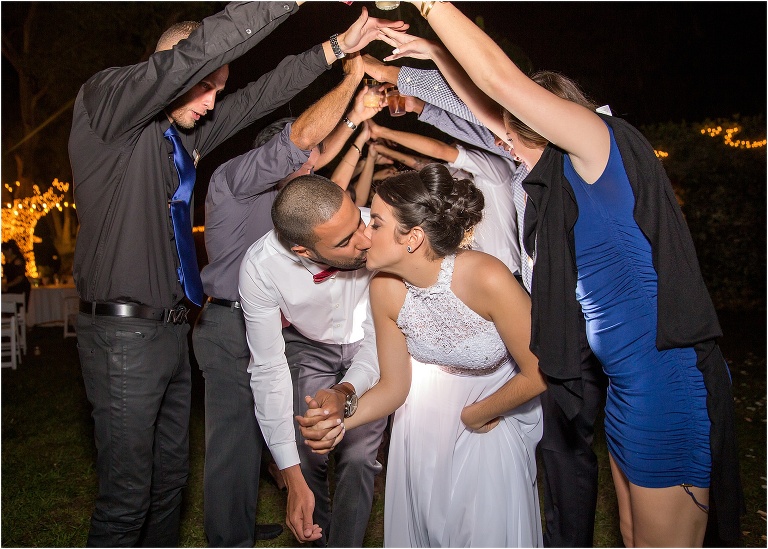 the bride and groom exit their reception through a human tunnel of all their friends and family at The Acre Orlando
