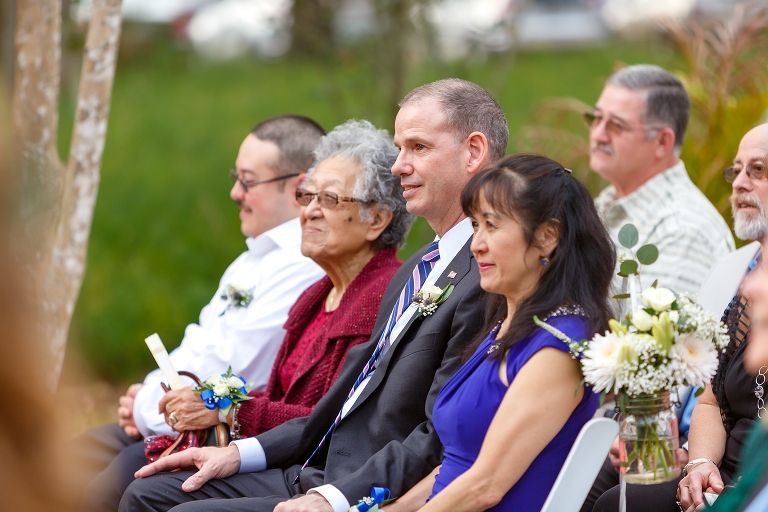 the father of the bride looks lovingly on as his oldest daughter marries the man of her dreams