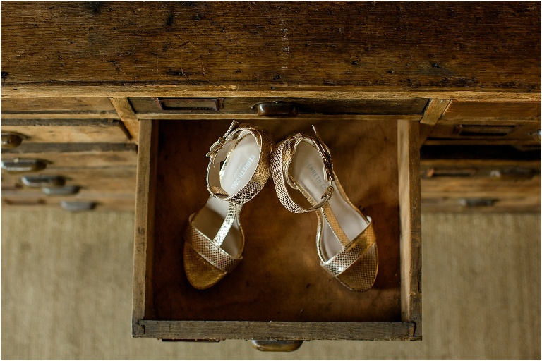 the bride's Kenneth Cole heels in the drawer of an antique library bookshelf at Oxford Exchange