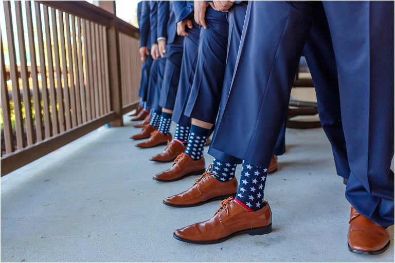 the groom & his groomsmen show off their patriotic American flag socks