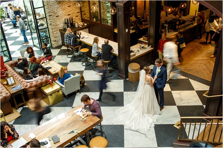 Bride & Groom frozen as the hustle and bustle of Oxford Exchange in Tampa swirls around them