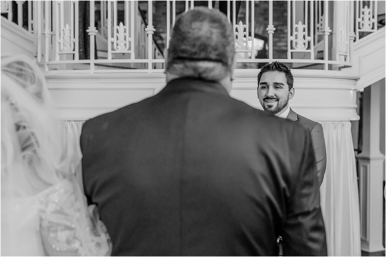 the groom sees his bride for the first time as her father walks her down the aisle