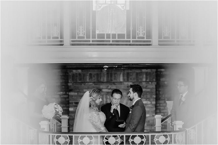 a peek at the bride & groom through the ornate white banisters at Orchid Garden in Downtown Orlando