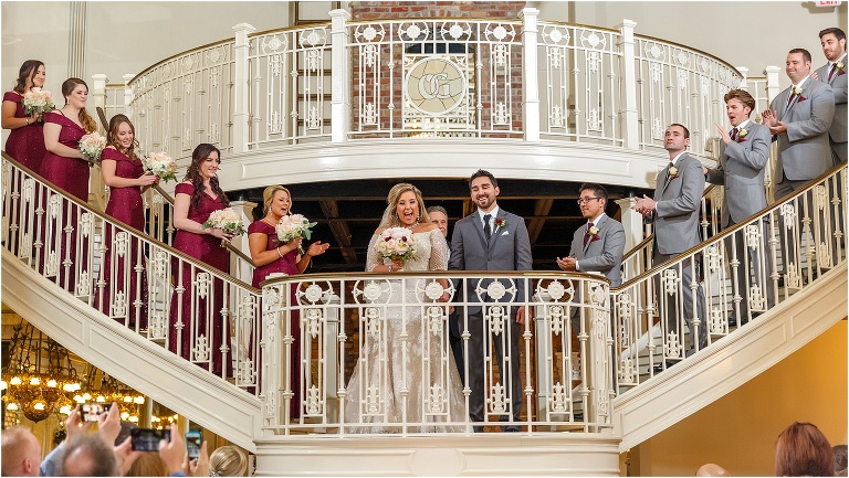 the bride & groom face their loved ones with huge grins for the first time as husband and wife