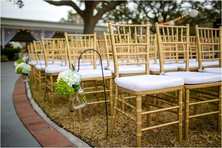 hanging mason jar flower pots lined the aisle at the Davis Island Yacht Club ceremony with beautiful gold chairs from A Chair Affair