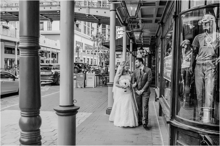 bride & groom stroll arm in arm down historic Church Street in Downtown Orlando