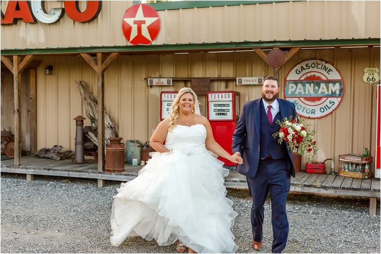 the groom carries his bride's Terri's Eustis Flower Shop bouquet as they run to their Hidden Barn Venue reception