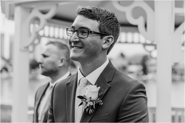 Black and white photo of the groom looking adoringly at his bride coming down the aisle at the Davis Island Yacht Club